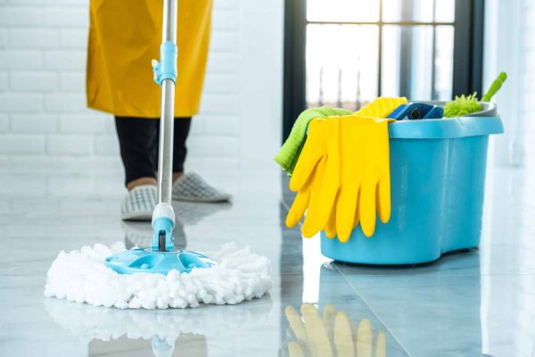Wife Housekeeping And Cleaning Concept, Happy Young Woman In Blue Rubber Gloves Wiping Dust Using Mop While Cleaning On Floor At Home